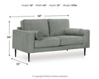 Charcoal loveseat with rolled arms and two round accent pillows; measures 60 in wide