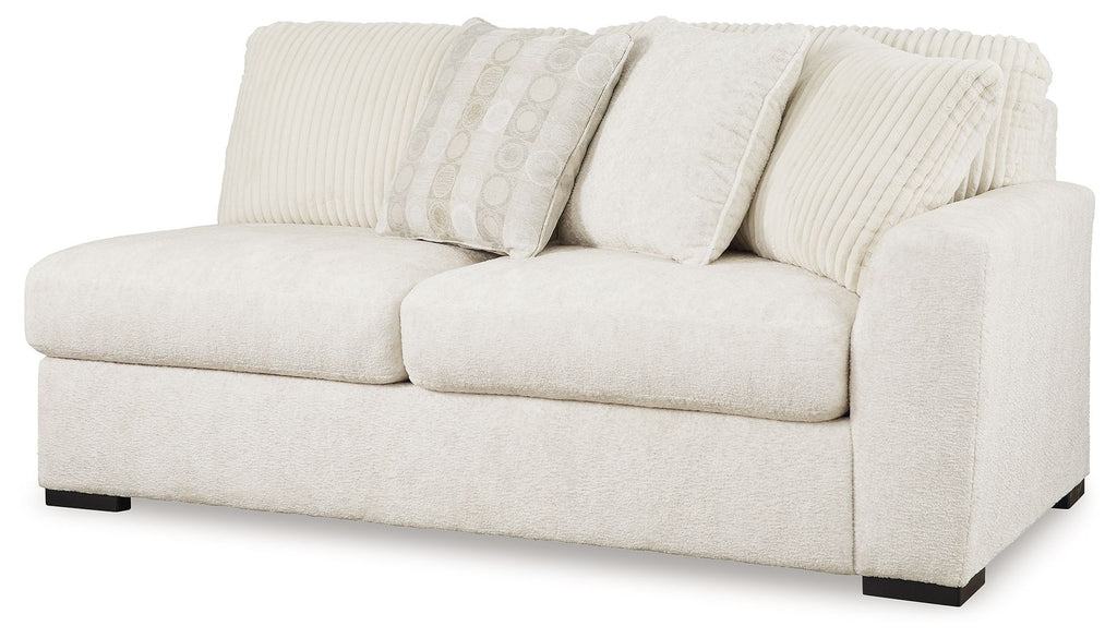 Ivory upholstered two-seat sofa with curved armrests, ribbed seat back, and cushions