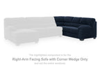 Right-arm facing navy sectional sofa with corner wedge and deep tufted back cushions
