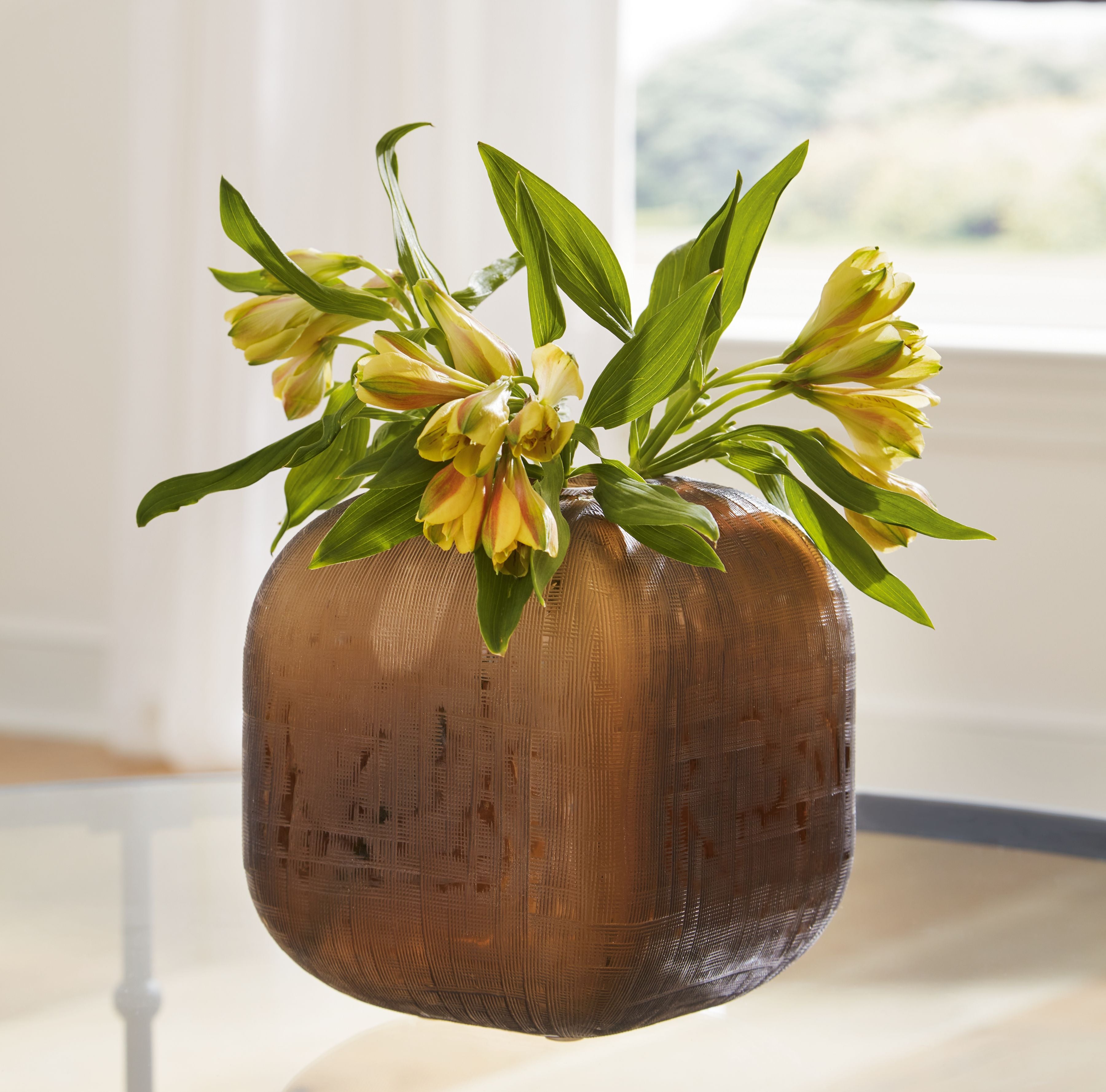 Rounded dark brown vase with open top and vertical textured pattern