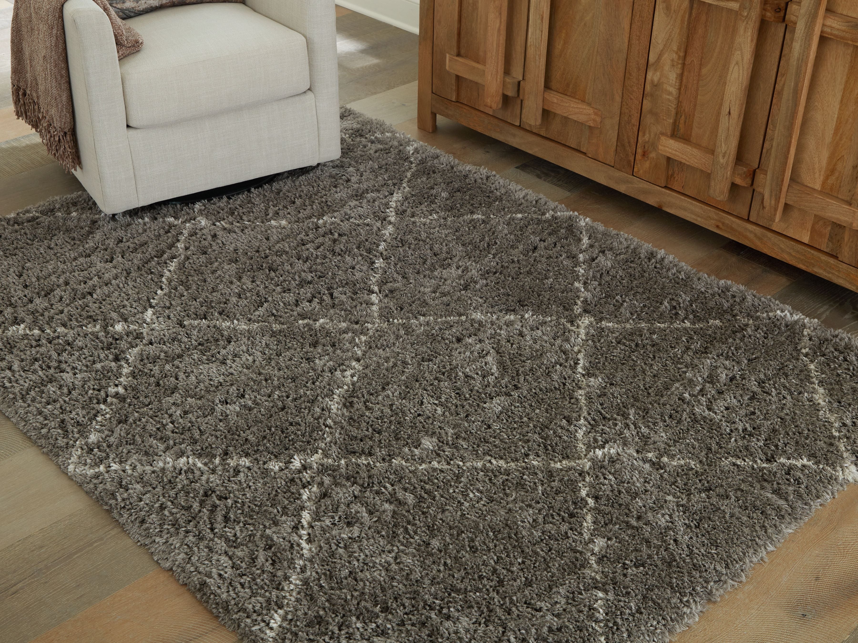 Dark gray area rug with mottled distressed pattern and shag texture