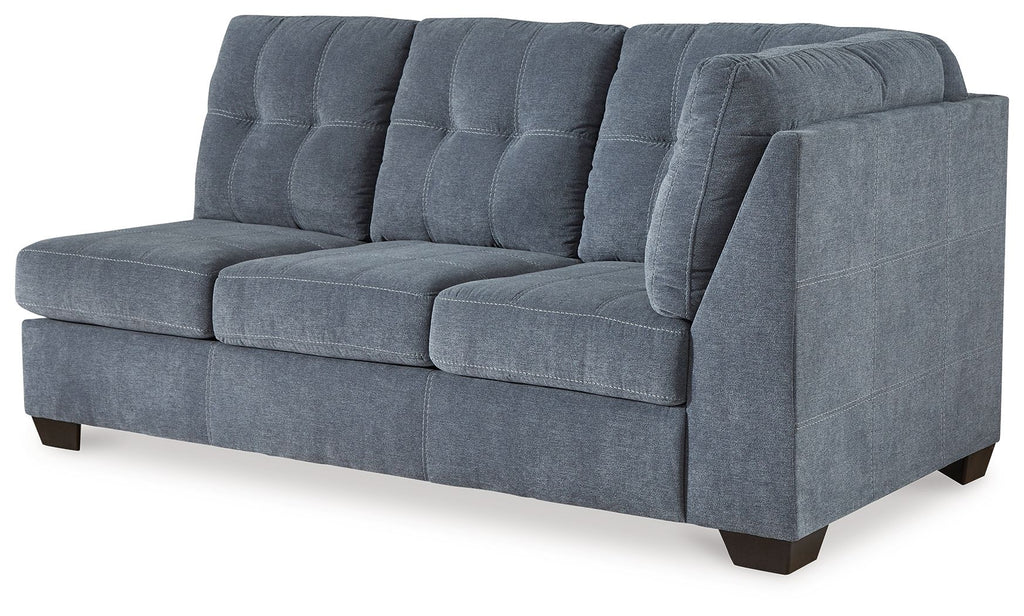 Blue denim full sofa sleeper with tufted back cushions, boxed arms, and dark legs.