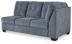 Blue denim full sofa sleeper with tufted back cushions, boxed arms, and dark legs.