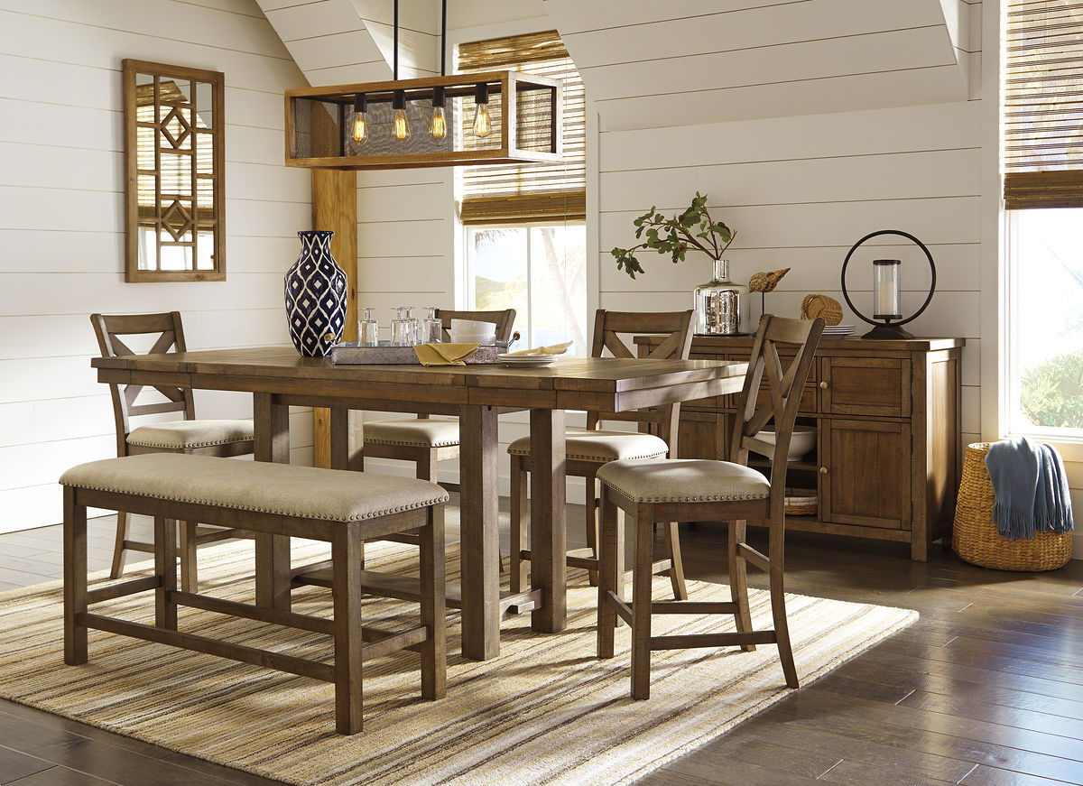 Counter-height dining table with cushioned bar stools and cross-back chairs in dark gray finish