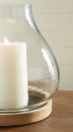 Clear glass vase candle holder with round wooden base and white candle
