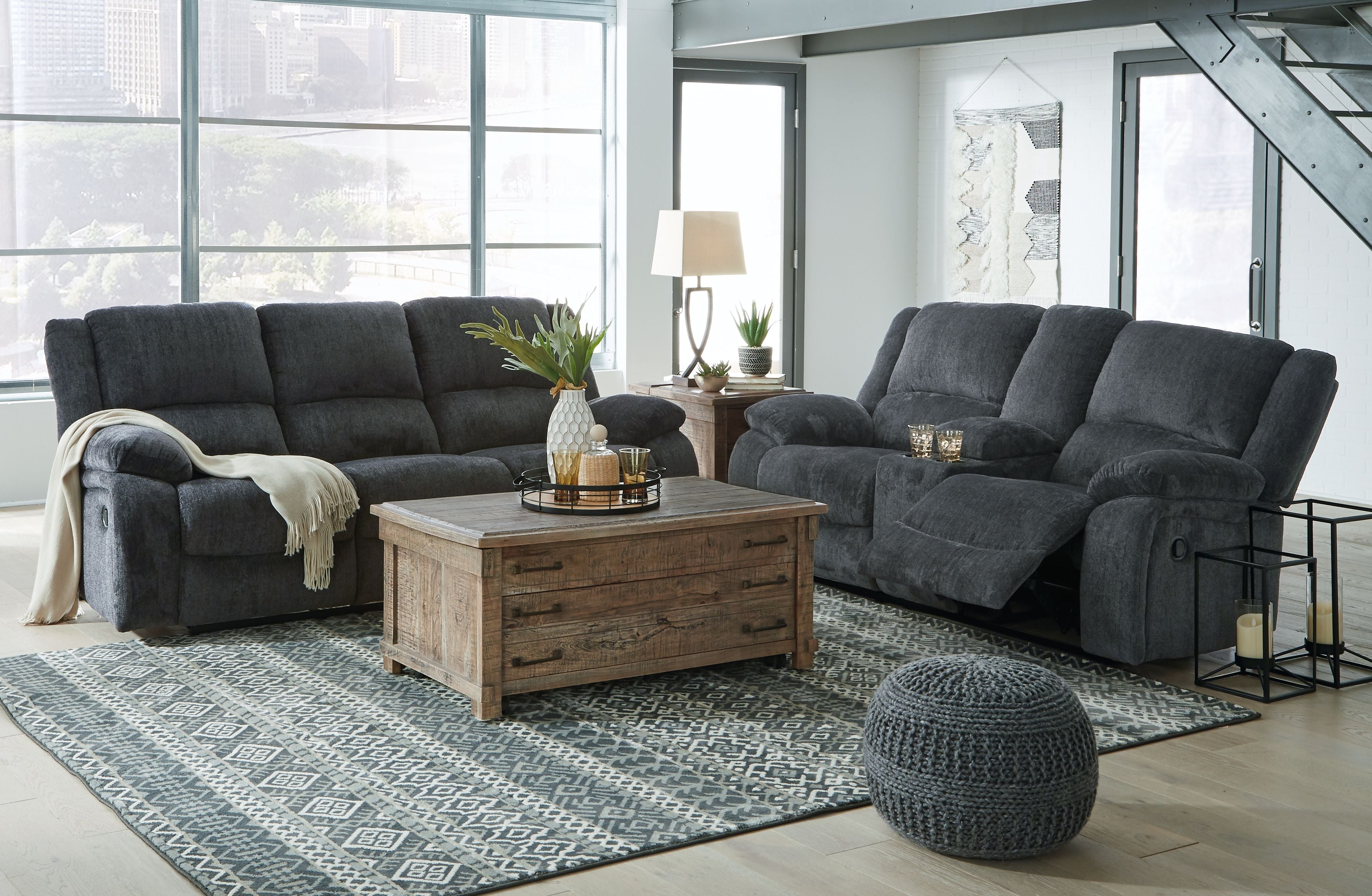 Dark gray reclining sofa, loveseat, and rocker recliner with padded armrests