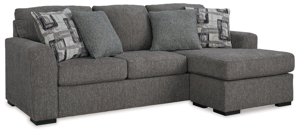 Pewter fabric sofa chaise with right chaise, three back pillows, and two patterned throws