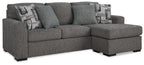 Pewter fabric sofa chaise with right chaise, three back pillows, and two patterned throws