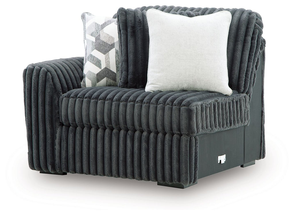 Gunmetal ribbed corner chair with curved arm, solid base, and two square cushions