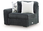 Gunmetal ribbed corner chair with curved arm, solid base, and two square cushions