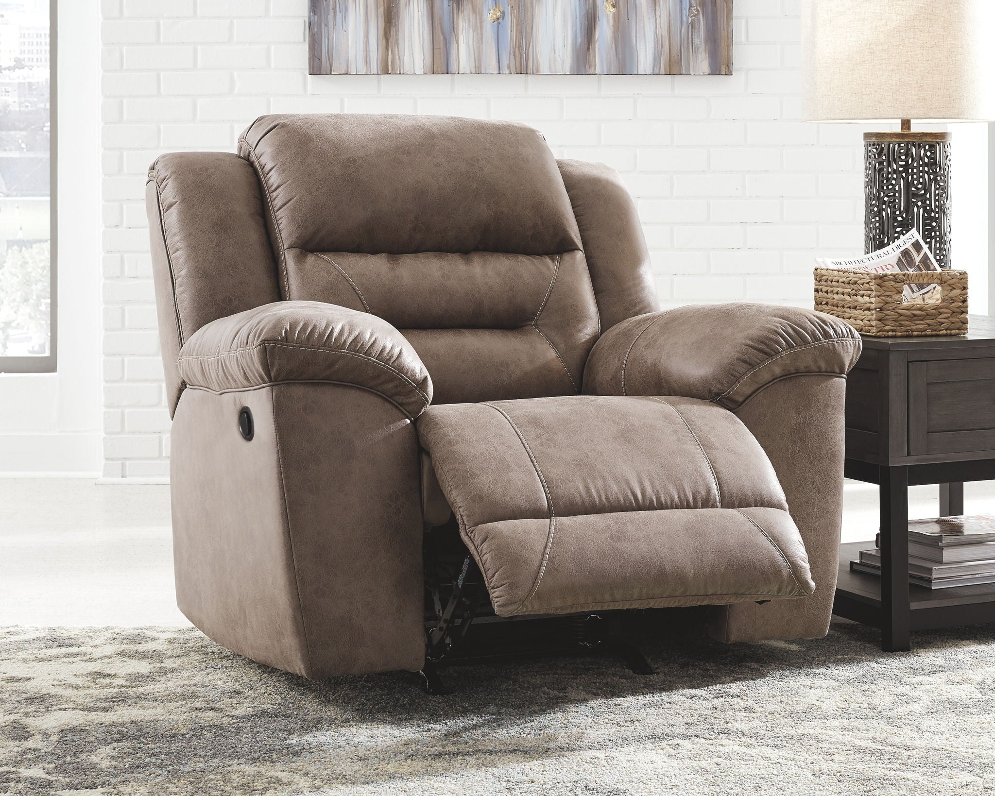 Gray reclining armchair with padded headrest and armrests, tufted seat cushions