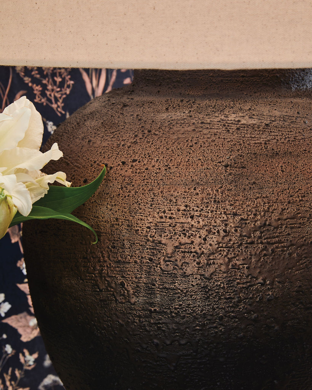 Brown metal lamp base with speckled, pitted finish