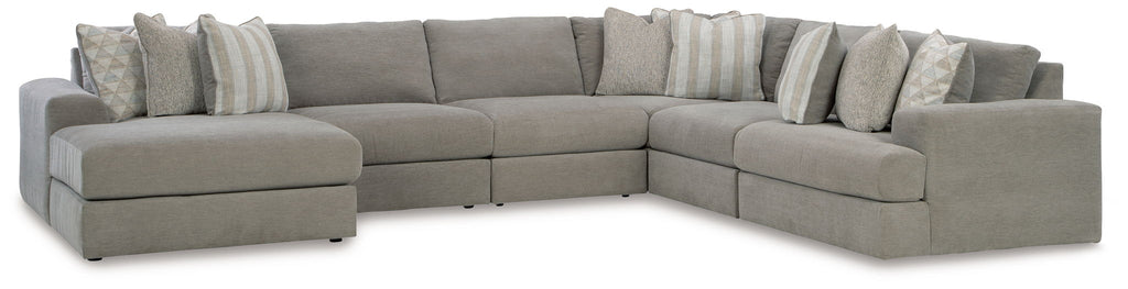Gray corner sectional with chaise-style seating and rows of accent pillows