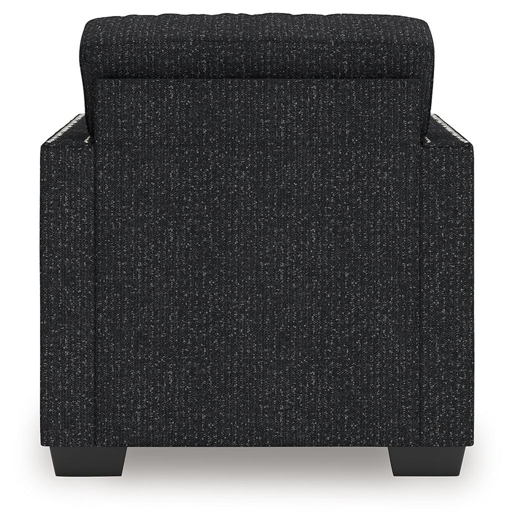 Black textured accent chair with rounded armrests and padded backrest