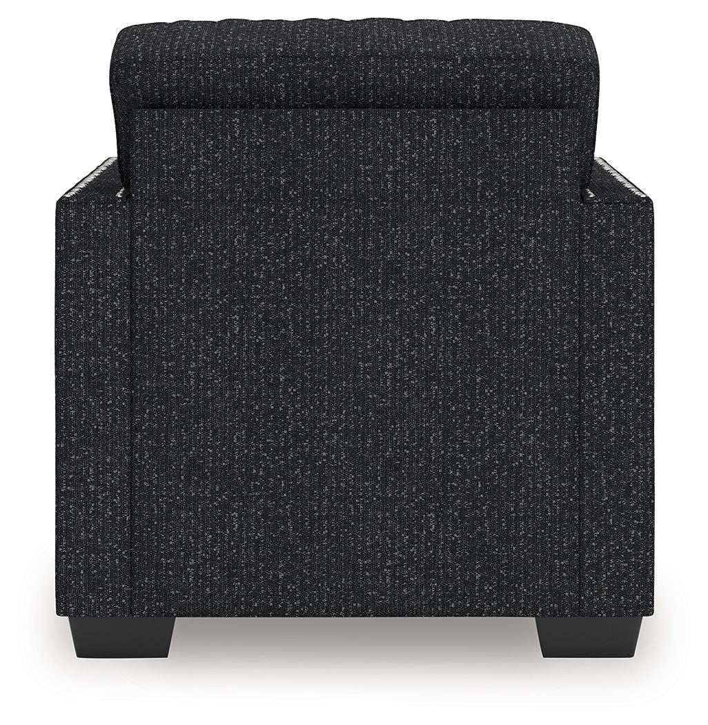 Black textured accent chair with rounded armrests and padded backrest