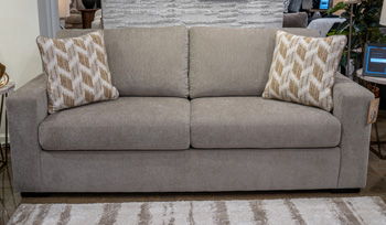 Gray fabric sofa with two back cushions and two patterned accent pillows