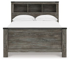 Gray bookcase panel bed with open-shelf headboard and white pillows on the mattress.