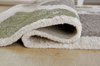 Folded gray and off-white shag rug with plush looped texture, low height
