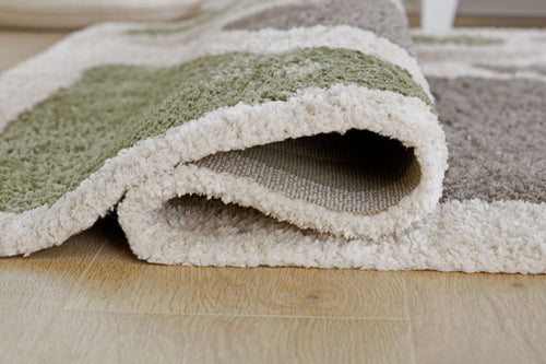 Folded gray and off-white shag rug with plush looped texture, low height