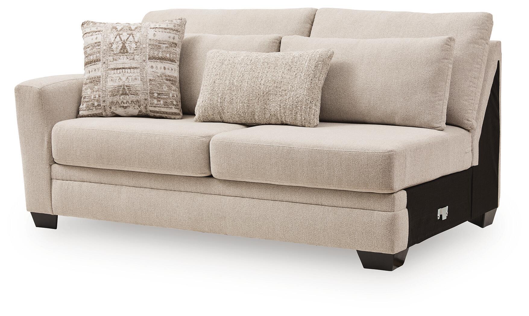 Beige upholstered loveseat with tufted back, wide seat, rolled arms, dark block legs, 3 pillows