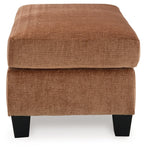 Clay upholstered ottoman with rounded rectangular top, textured fabric, dark tapered legs