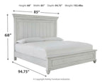 White panel bed with tall headboard and low footboard, featuring vertical panel detailing.