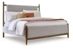 Upholstered bed with grey fabric panel and dark brown wood frame, made bed
