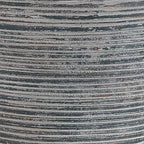 Close-up of ribbed blue-gray ceramic lamp base with speckled texture