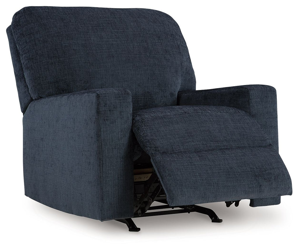 Rocker recliner chair in dark blue upholstered fabric with extended footrest.