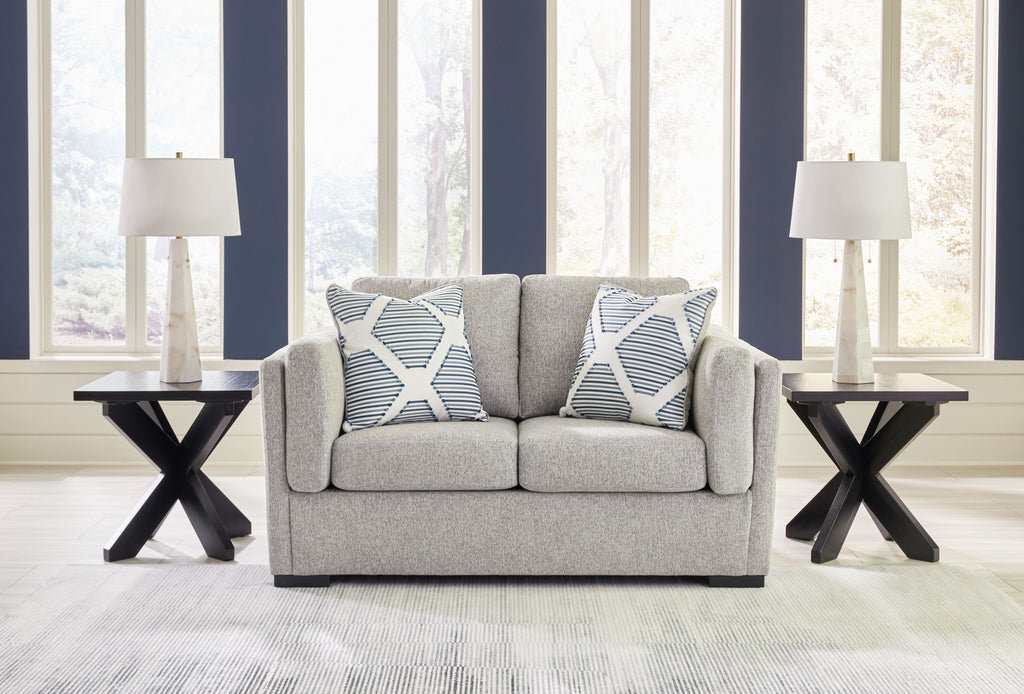 Gray loveseat sofa with two white-and-blue striped throw pillows