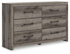Six-drawer dresser with gray-brown wood finish and black bar pulls, front view