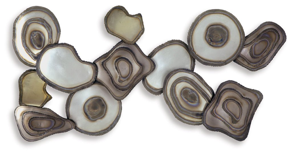 Multi-piece wall decor cluster of resin stone discs in cream, tan, and gray with rings