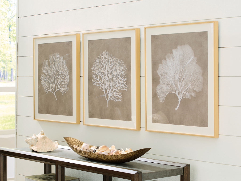 Three framed tree silhouette wall art prints in taupe and white, each in a light frame