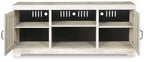 Light beige wood TV stand with three open shelves and two side doors