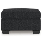 Dark textured upholstered ottoman with rectangular profile and short block legs