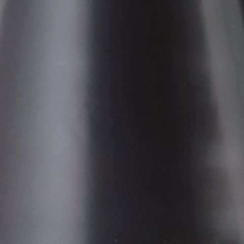 Black metal lamp shade close-up with smooth brushed surface