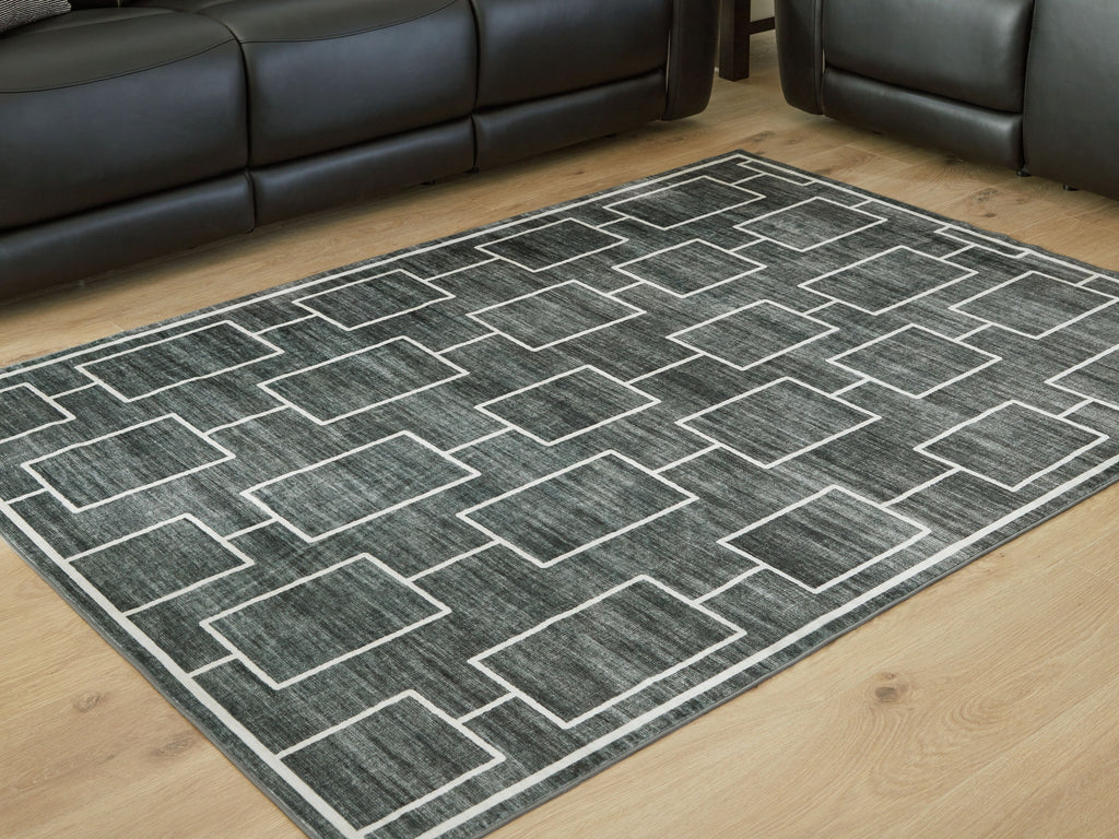 Elderland washable rug angled view with dark gray geometric pattern on wood floor