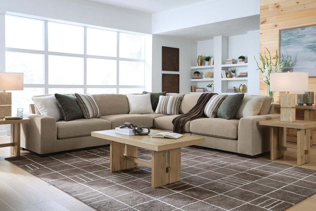 Light brown sectional sofa with chaise and striped accent pillows in living space