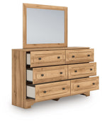 Aleaport dresser with light brown wood, mirror, and six drawers with round knobs