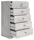 Whitewash chest of drawers with ornate top, side view showing open drawers and knobs