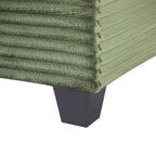 Green corduroy sofa armrest detail with dark base legs