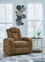 Brown power recliner with tall back, cushioned arms, and matching headrest