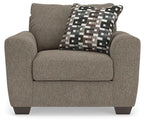 Upholstered chair and a half with dark gray fabric and geometric patterned seat pillow
