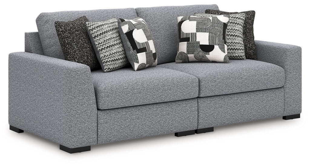 Gray fabric sectional sofa with patterned accent pillows and wide chaise-style seat