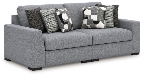 Gray fabric sectional sofa with patterned accent pillows and wide chaise-style seat