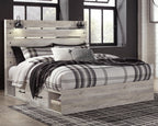 Beige panel bed with plaid bedding and two front storage drawers, slatted headboard