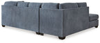 Blue sectional sleeper sofa with tufted back and chaise corner, padded arms