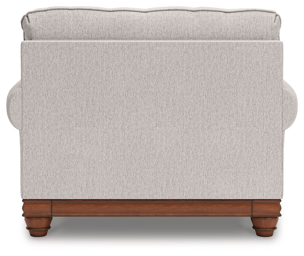 Light-gray chair and a half back with rounded arms and dark wood legs
