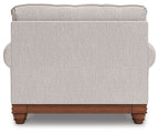 Light-gray chair and a half back with rounded arms and dark wood legs