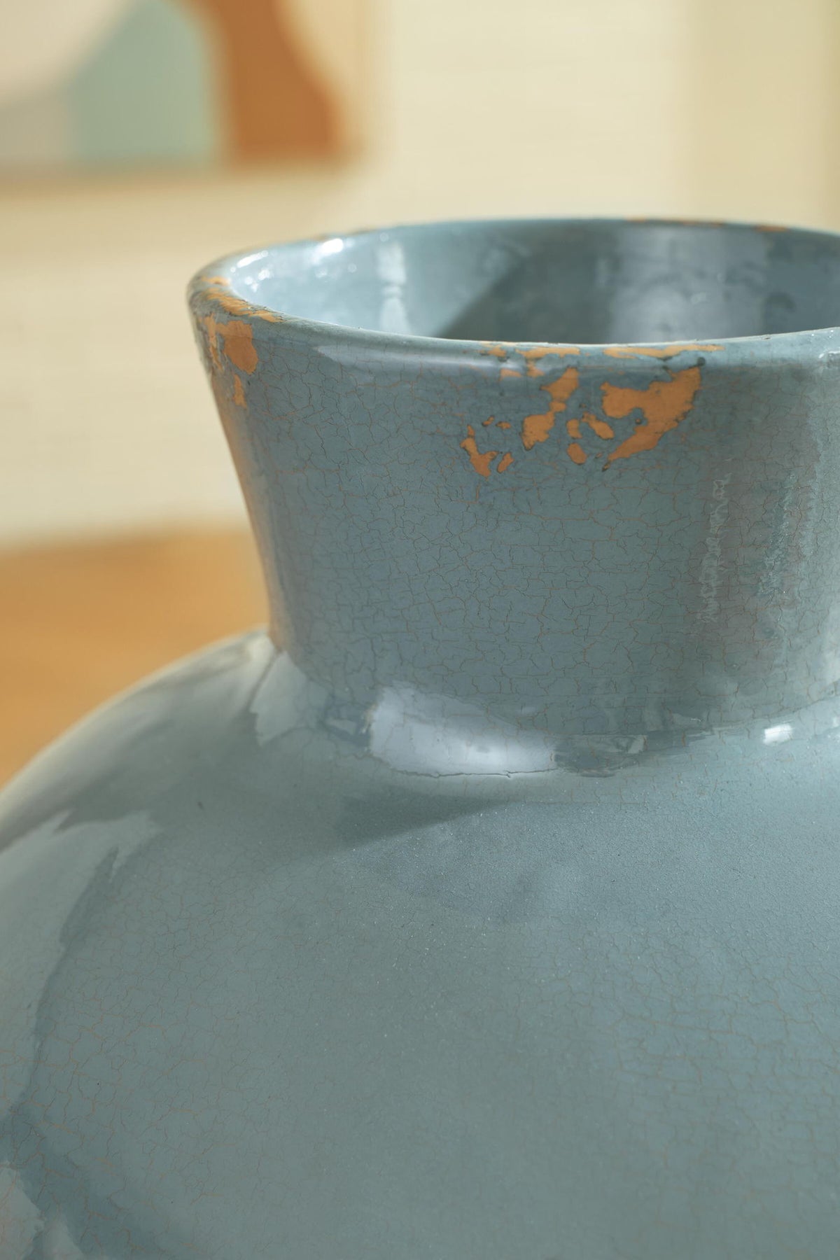 Blue ceramic vase rim and upper body with orange speckled glaze, glossy finish